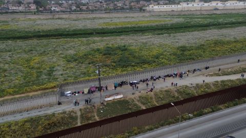 Migrantes acampan en el muro fronterizo para conseguir asilo político en Estados